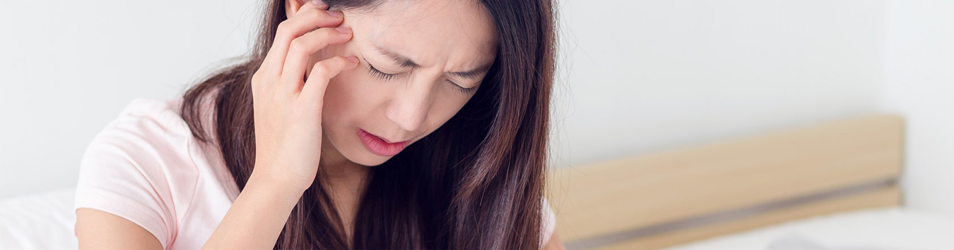 Women with pain holding head